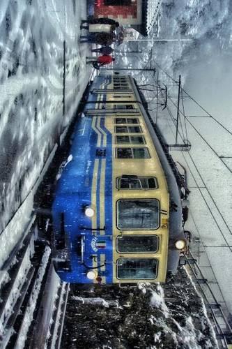 Blue and Yellow Trolley Train in the Snow